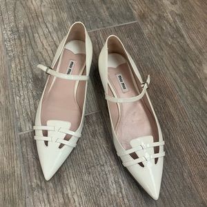 Miu Miu white pointy toe patent leather ballet flat.